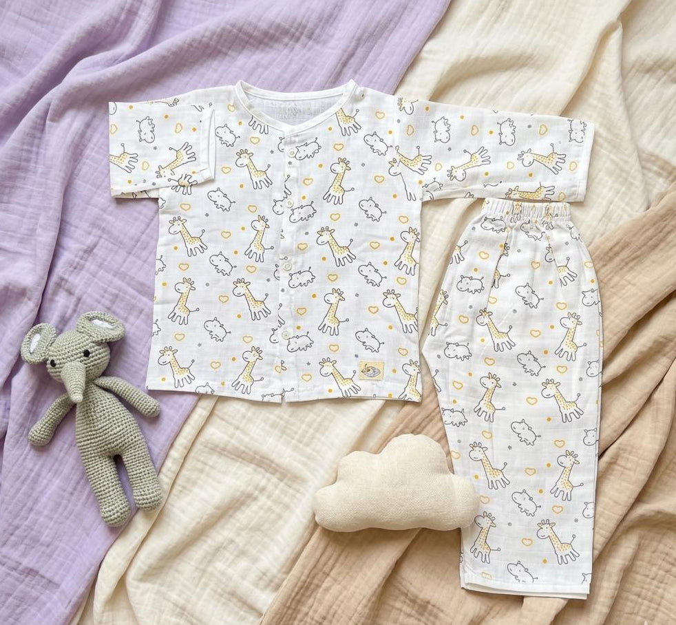 Baby outfit with patterned shirt and pants on a soft fabric background