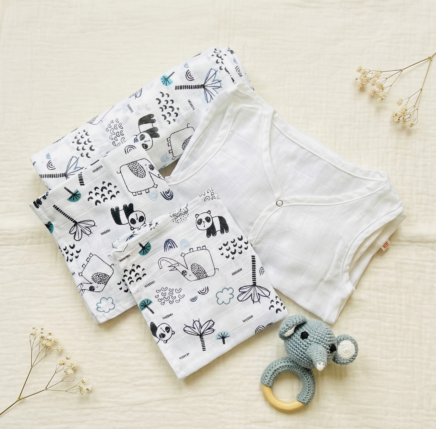 Baby shorts with animal pattern and teething ring on a light background