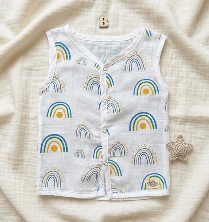 Baby vest with rainbow pattern on a soft beige fabric background
