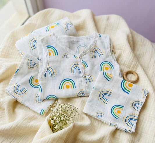 Baby outfit with rainbow pattern on a soft fabric background