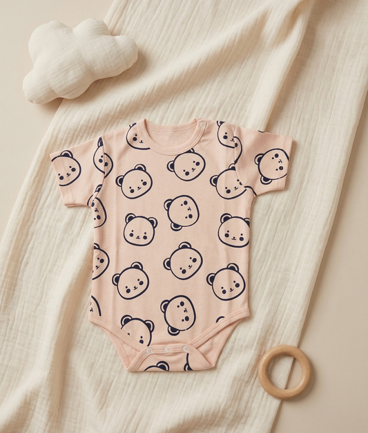 Baby onesie with bear pattern on a peach onesie soft beige background